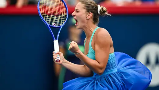 Marta Kostyuk Shines in Orange Swimsuit on Island Escape