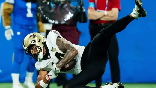 Saints' Devaughn Vele secures first down vs. Lions at Ford Field on Sept 13, 2026